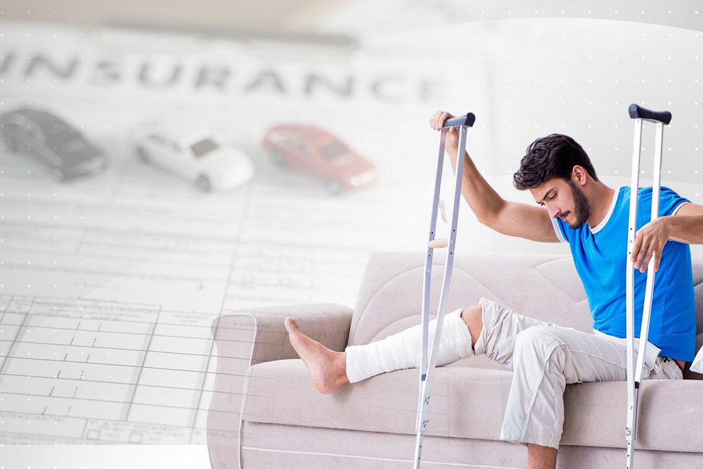 Man with leg injury on crutches, sitting on a couch with insurance documents in the background.
